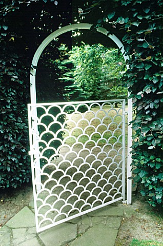 WHITE_PATTERNED_METAL_GATE_LEADING_TO_THE_ENCLOSED_CAMELLIA_GARDEN_THE_POSTERN