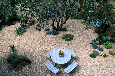 OVERVIEW_OF_CLARE_MATTHEWS_GRAVEL_GARDEN__READING_WITH_LIGHT_BLUE_GARDEN_FURNITURE_AND_OLD_APPLE_TRE