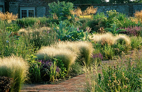 PERENNIAL_PLANTING_IN_WALLED_GARDEN_BY_CHRISTOPHER_BRADLEYHOLE_REPEATED_CLUMPS_OF_STIPA_TENUISSIMA__