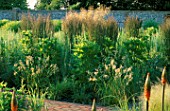 PERENNIAL PLANTING IN WALLED GARDEN BY CHRISTOPHER BRADLEY-HOLE: ANGELICA ARCHANGELICA AND CALAMAGROSTIS X ACUTILFORA KARL FOERSTER