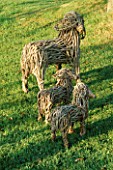 SHEEP MAY SAFELY GRAZE : WICKER SCULPTURES OF A EWE AND TWO LAMBS. NYEWOOD HOUSE   WEST SUSSEX.