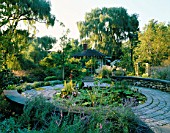 VIEW OF KITCHEN TERRACE LILY POOL IN ALL ITS SUMPTUOUS DETAIL - LOTUS  CANNA AND WATER LETTUCE. DESIGNER: JAMES VAN SWEDEN. AMERICA