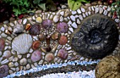 DETAIL OF SHELL & FOSSIL RAISED BORDER.  WARREN FARM CENTRES THE ESSENCE OF LIFE COURTYARD GARDEN DESIGNED BY ROSAMOND PAGE. CHELSEA 2000