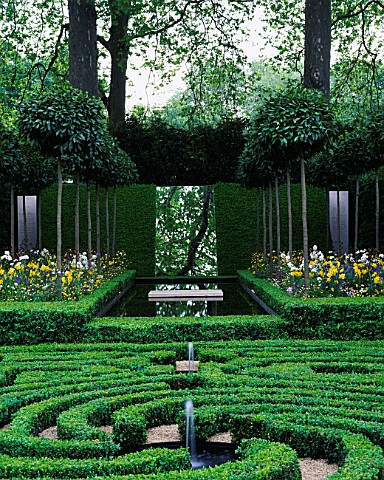 BOX_MAZE_WITH_SLOPING_WALL_AND_MIRROR__MIXED_BORDERS_AND_CLIPPED_BAY_TREES_LAURENTPERRIER_HARPERS__Q