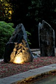 NATURAL ROCKS LIT FROM BELOW WITH RAKED GRAVEL AND BAMBOO. THE ZEN INSPIRED GARDEN. DESIGNED BY SPIDERGARDEN.COM  LIGHTING BY COTSWOLD ELECTRICAL. CHELSEA 2000