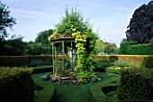 BANDSTAND IN THE HERB GARDEN COVERED WITH GOLDEN HOP. EASTLEACH HOUSE  GLOUCESTERSHIRE