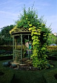 BANDSTAND IN THE HERB GARDEN COVERED WITH GOLDEN HOP. EASTLEACH HOUSE  GLOUCESTERSHIRE