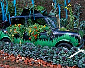 OLD CAR PLANTED WITH NASTURTIUMS AND CABBAGE. GARDENING WHICH? GARDENS FOR PEOPLE   HAMPTON COURT 2000.