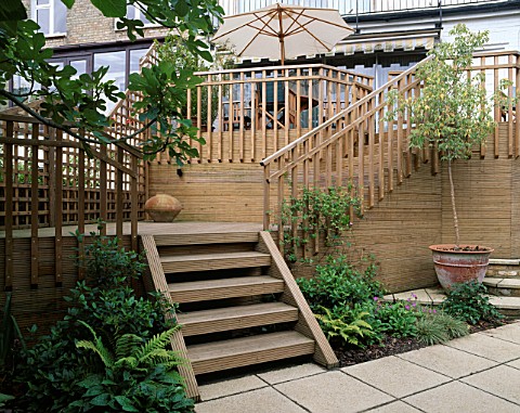 STEPS_LEAD_FROM_PAVED_AREA_ONTO_WOODEN_DECK_AND_HIGHER_DECK_WITH_TABLE_AND_CHAIRS_DESIGNER__SARAH_LA