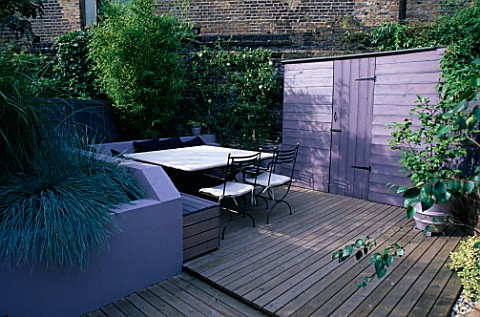 GARDEN_WITH_DECKING_DESIGNED_BY_JOE_SWIFT_AND_THAMASIN_MARSH_LILACGREY_SHED_AND_RAISED_BED_WITH_BLUE
