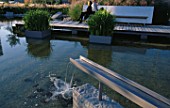 GALVANISED METAL SHUTE FORMS WATER SPOUT IN MINIMALIST WATER GARDEN DESIGNED BY ULF NORDFJELL.  HEDENS LUSTGARD  SWEDEN