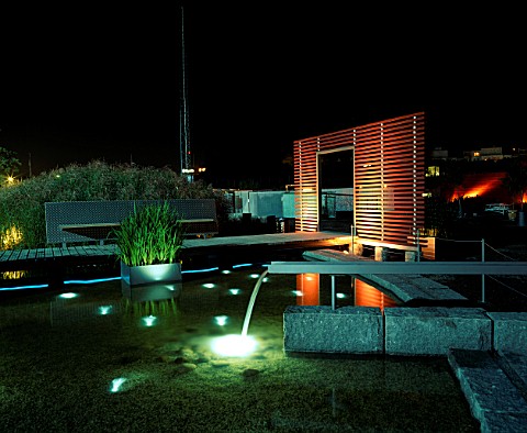 NIGHT_TIME_VIEW_ACROSS_MINIMALIST_WATER_GARDEN__DESIGNED_BY_ULF_NORDFJELL__DECKING__SCREEN_AND_WATER