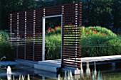 WATER GARDEN WITH ENTRANCEWAY AND METAL WALKWAY  DESIGNED BY ULF NORDFJELL. HEDENS LUSTGARD  SWEDEN