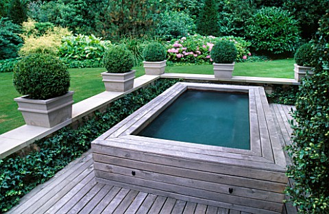 DECKED_TERRACE_WITH_BOX_BALLS_AND_HOT_TUB_WITH_LAWN_BEYOND