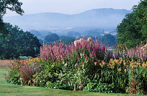 VIEW_TO_FLOWERBEDS_WITH_THE_SOUTH_DOWNS_BEHIND_NYEWOOD_HOUSE__HAMPSHIRE