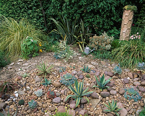 RED_GABLES__WORCESTERSHIRE_THE_COBBLED_GARDEN_WITH_AGAVES_AND_ECHEVERIAS