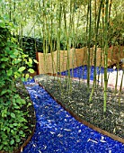 GLASS GARDEN: BLUE GLASS AND GREEN MARBLES ACT AS MULCH BENEATH BAMBOOS WITH ROPE FENCING: DESIGN BY ANDY CAO AND STEPHEN JERROM  USA