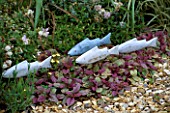 WOODEN FISH SCULPTURE IN DAVID AND MARIE CHASES GARDEN  HAMPSHIRE