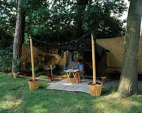 JUNGLE_OUTPOST_STEVEN_AND_DANIEL_JAMES_WITH_BAMBOO_AND_CAMOUFLAGE_NET_CANOPY__SHED__HAMMOCK_AND_LEOP