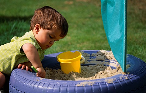 JOSHUA_PLAYING_IN_THE_TYRE_SANDPIT_WITH_KITE_MATERIAL_SAIL
