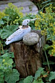 WOODEN SEAGULL ON A POST SURROUNDED BY ALCHEMILLA MOLLIS IN DAVID AND MARIE CHASES GARDEN  HAMPSHIRE