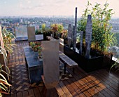 AFRICAN THEMED ROOF TERRACE:IROKO DECKING    ZINC-WRAPPED TABLE WITH KALANCHOE THYRSIFLORA  STAINLESS STEEL  CHAIRS   STEEL SHIELD SCULPTURE & PHYLLOSTACHYS.  DESIGN: S. WOODHAMS
