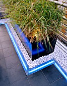 ROOF GARDEN DETAIL:  CONTAINER  WHITE PEBBLES  NEON STRIP LIGHTING  AND BLACK SLATE. GARDEN DESIGNED BY STEPHEN WOODHAMS