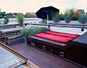 ROOF GARDEN DESIGNED BY STEPHEN WOODHAMS: DECKED TERRACE WITH GALVANISED CONTAINERS WITH  FESTUCA GLAUCA  STIPA ARUNDINACEA  STIPA TENUIFOLIA. CANVAS UMBRELLA/SUN LOUNGER