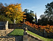 VIEW TOWARDS THE CHURCH FROM THE STEPS AT ENGLEFIELD HOUSE  BERKSHIRE  WITH RHUS TYPHINA AND STONE BALUSTRADE