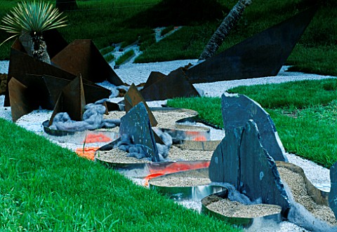 GRAVEL__SHEETS_OF_STEEL_AND_PORTUGUESE_SLATE_IN_THE_HAPPENING_GARDEN_BY_TONY_HEYWOOD_AT_THE_WESTONBI