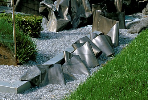TURF__GRAVEL_AND_SHEETS_OF_STEEL_IN_THE_HAPPENING_GARDEN_BY_TONY_HEYWOOD_AT_THE_WESTONBIRT_FESTIVAL_