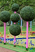 WESTONBIRT FESTIVAL OF GARDENS  2002: THE FANTASY GARDEN BY CANDACE BAHOUTH: ARTIFICIAL TOPIARY BALLS ON PINK WOODEN POLES