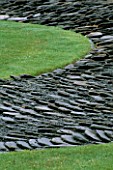 SLATES AND GRASS IN THE SWIMMER  A JAPANESE INSPIRED LANDSCAPE BY TONY HEYWOOD OF CONCEPTUAL GARDENS AT THE WATER GARDENS  LONDON