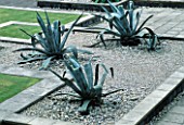 GIANT AGAVES IN GRAVEL AT THE WATER GARDENS  LONDON. GARDEN CREATED BY TONY HEYWOOD OF CONCEPTUAL GARDENS