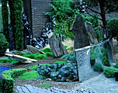 HELTER SKELTER   GARDEN CREATED BY TONY HEYWOOD OF CONCEPTUAL GARDENS  LONDON: BOX HEDGING   ROCKS  SLATE  A CURVED MIRROR OF MARINE STEEL & TWISTED LEAD