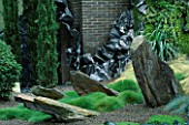 HELTER SKELTER   GARDEN CREATED BY TONY HEYWOOD OF CONCEPTUAL GARDENS  LONDON: ROCKS  TWISTED LEAD AND GRASSES