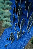 HELTER SKELTER   GARDEN CREATED BY TONY HEYWOOD OF CONCEPTUAL GARDENS  LONDON: FESTUCA GLAUCA  SLATE AND BLUE GRAVEL
