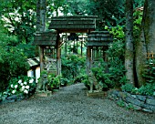 ENTRANCE TO THE KOI POND AREA WITH HYDRANGEAS. DESIGNERS: ILGA JANSONS AND MIKE DRYFOOS