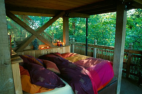 AN_OUTDOOR_BED_IN_THE_THE_MULTI_STOREY_TREE_HOUSE_IN_THE_WOODLAND_DESIGNERS_ILGA_JANSONS_AND_MIKE_DR