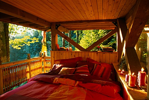 AN_OUTDOOR_BED_IN_THE_THE_MULTI_STOREY_TREE_HOUSE_IN_THE_WOODLAND_DESIGNERS_ILGA_JANSONS_AND_MIKE_DR