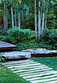 VIEW ALONG FRONT WOODEN PATH WITH LAWN   ROCKS  DECKING AND ASPENS. DESIGNER BOB SWAIN  SEATTLE  USA