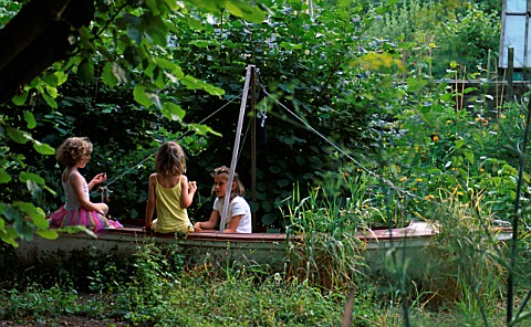 CHILDREN_PLAYING_IN_AN_OLD_BOAT_IN_ROSEMARY_PEARSONS_GARDEN__READING