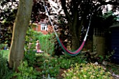 A HAMMOCK STRUNG BETWEEN TWO TREES IN ROSEMARY PEARSONS GARDEN  READING