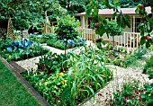 FAMILY POTAGER BY CLARE MATTHEWS: GRAVEL  CABBAGES  CLIPPED BOX AND BAY  APPLES  WOODEN OBELISKS AND A SUMMERHOUSE