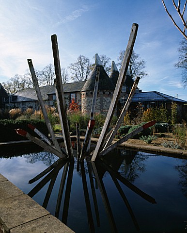 BURY_COURT__SURREY__IN_AUTUMN_RECTANGULAR_POND_AND_SCULPTURE_BY_PAUL_ANDERSON_REFLECTED_IN_WATER_WIT