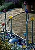 WATER FEATURE WITH MARBLES AND COLOURED GLASS LIGHTS ON METAL STICKS. TATTON PARK 2002/ DESIGNERS: CHAPMAN BRYNE - DANIEL