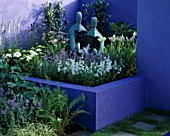 HAMPTON COURT 2002/ MERCEDES - BENZ. DESIGNER: JANE MOONEY: BRIGHT BLUE WALL AND RAISED BED PLANTED WITH HERBACEOUS PLANTS. SCULPTURE BY JOHN BROWN