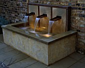 WATER FEATURE: RAISED WATER FEATURE WITH COPPER SPOUTS. DESIGNER: CLAIRE MEE