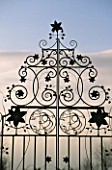 ORNATE METAL CLEMATIS GATES AT EASTLEACH HOUSE  GLOUCESTERSHIRE