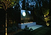 SANCTUARY GARDEN SPONSORED BY MERRILL LYNCH AT THE CHELSEA FLOWER SHOW 2002: DESIGNED BY STEPHEN WOODHAMS: WATER FEATURE LIT UP AT NIGHT
